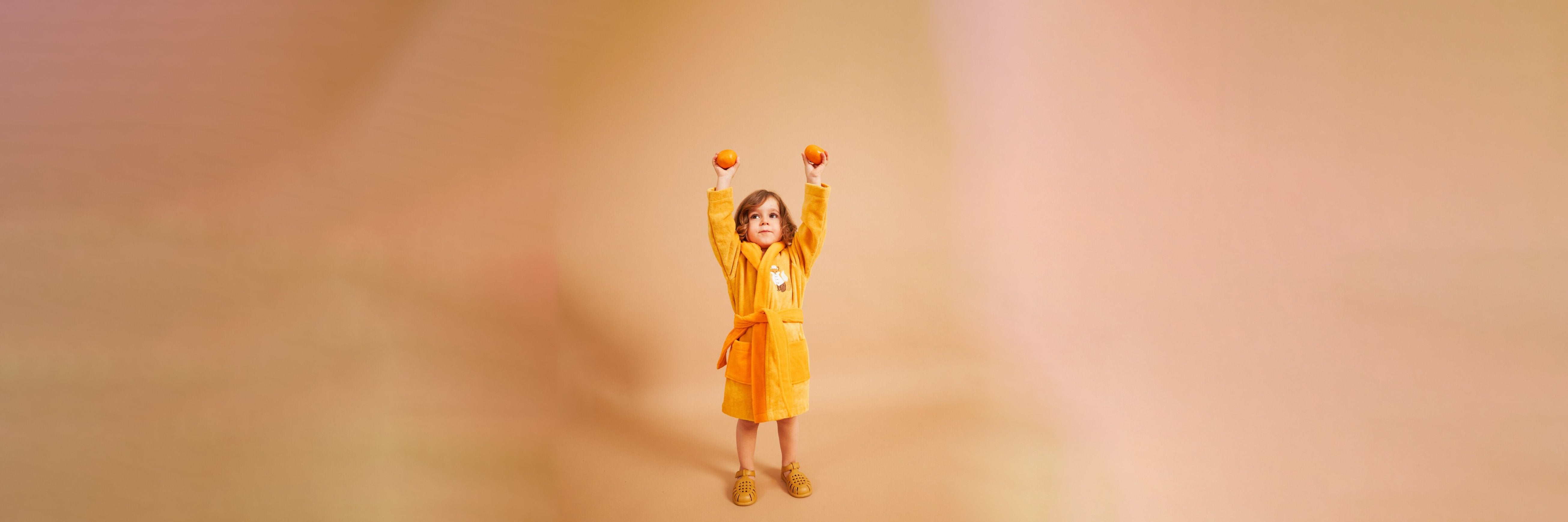 a kid wearing yellow bathrobe from tiny little love baby towels & bathrobes collections