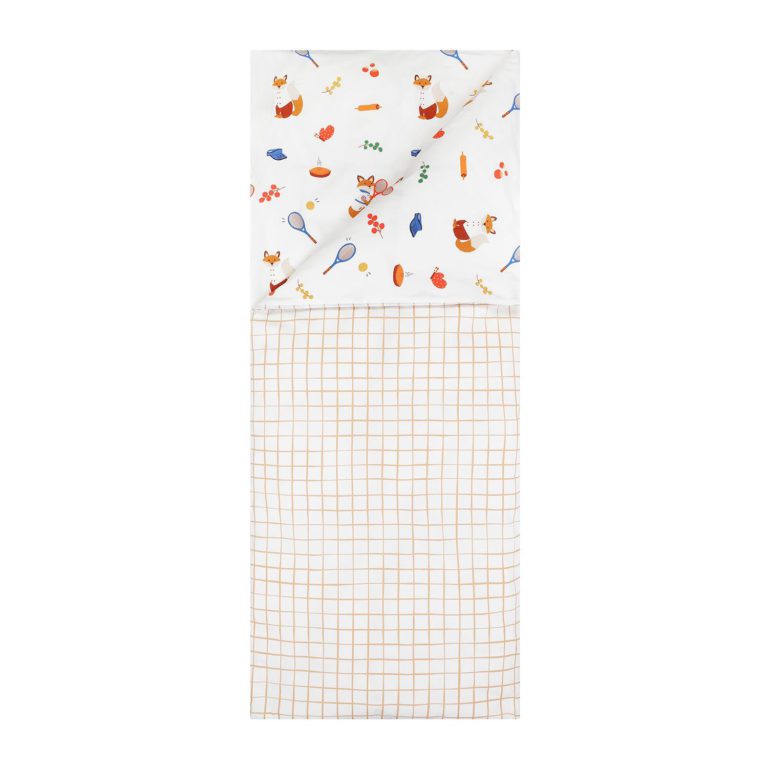 A folded beige duvet cover with a multicolor pattern featuring illustrations of foxes