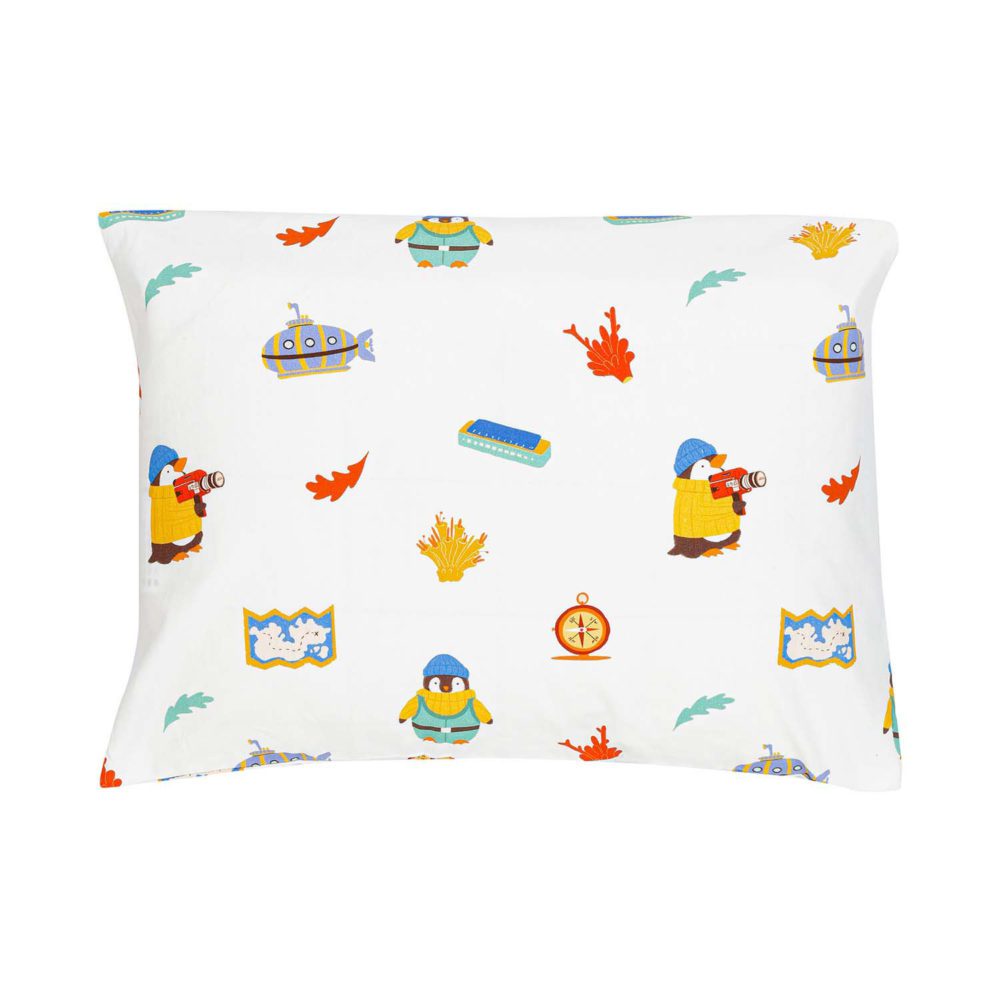 A pillow wrapped in toddler pillow case with a pattern of illustrated penguins