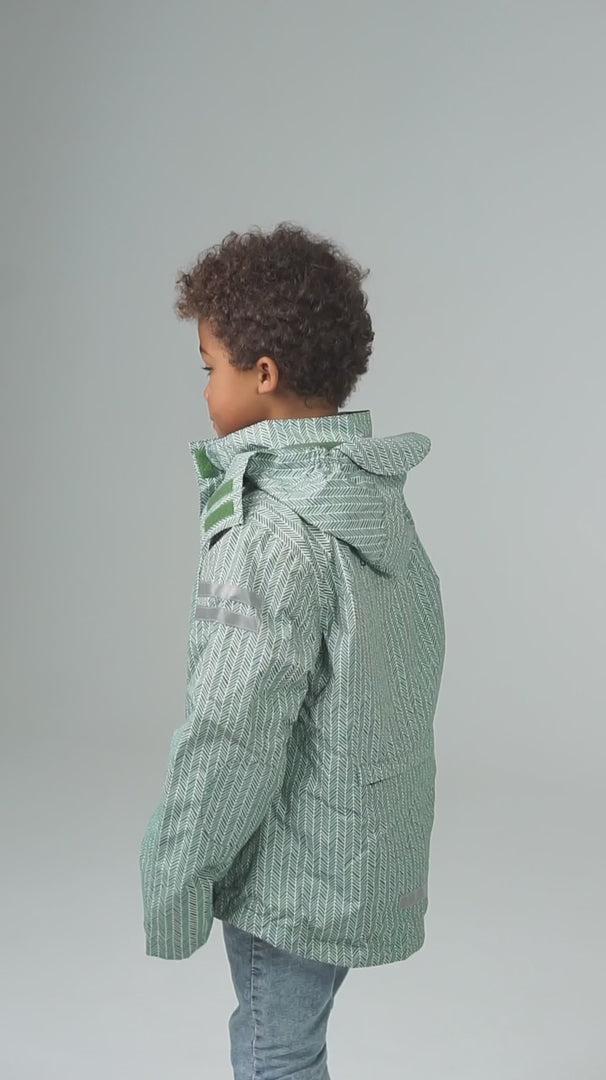 Child wearing a green jacket